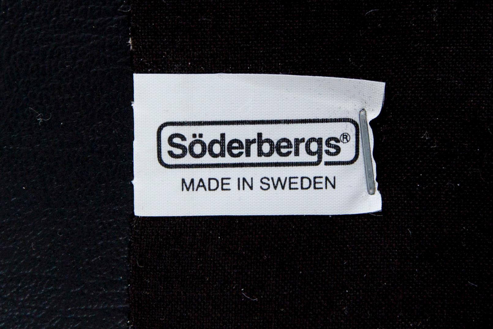 A leather swivel armchair and stool, Söderbergs  1980s.