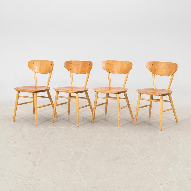 A set of four birch and teak veneered chairs from Bröderna Wigells stolfabrik, Malmbäck mid 20th century.