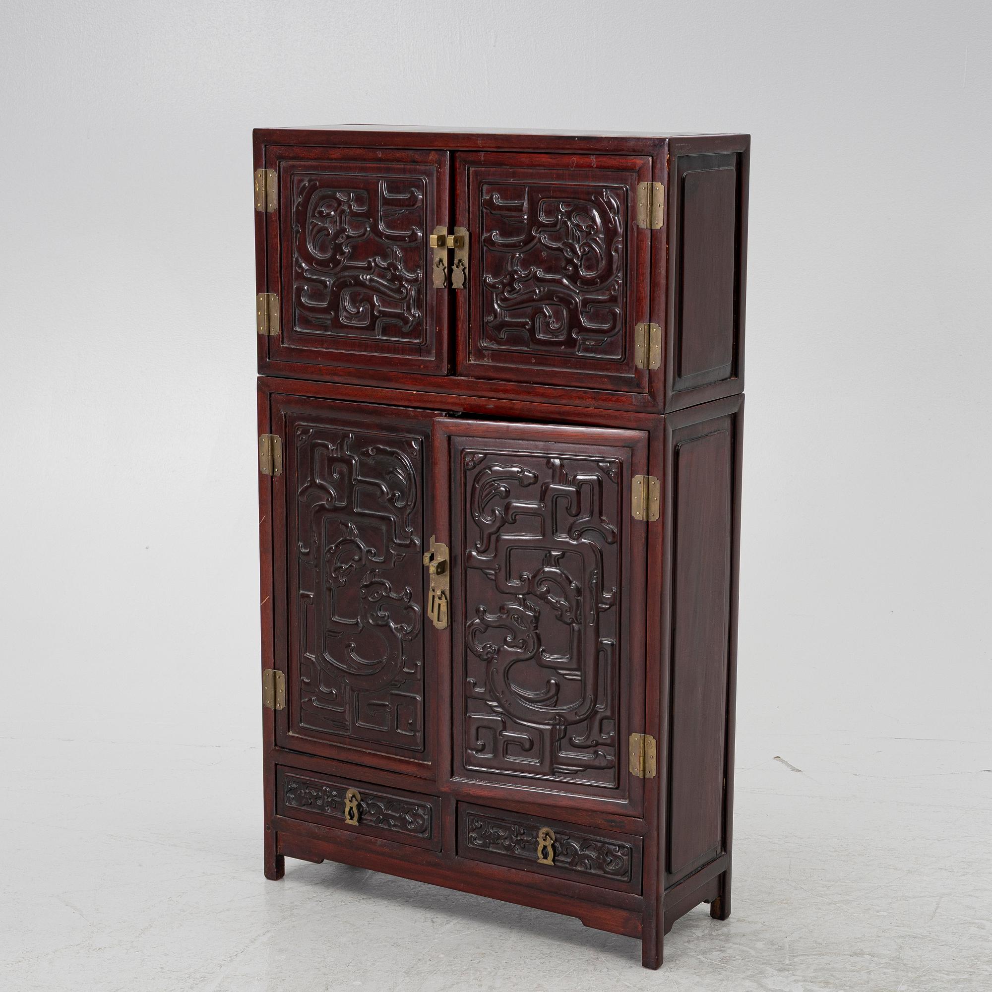 A small Chinese stained wood two part cabinet, 1900s.