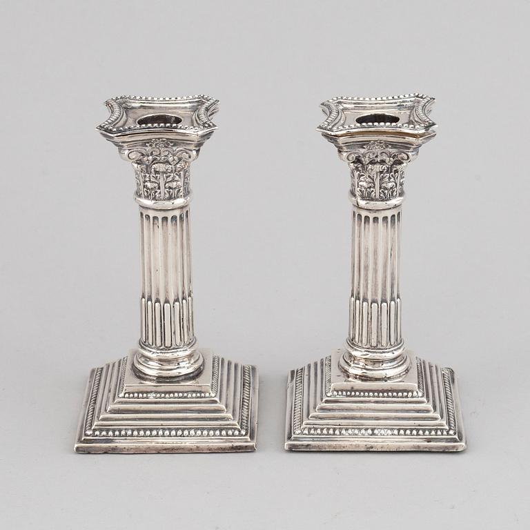 A pair of silver candle sticks, England.