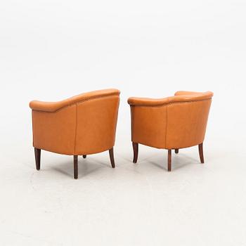 A set of two  1940s leather armchairs.