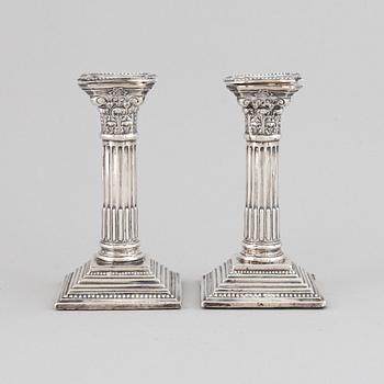 A pair of silver candle sticks, England.