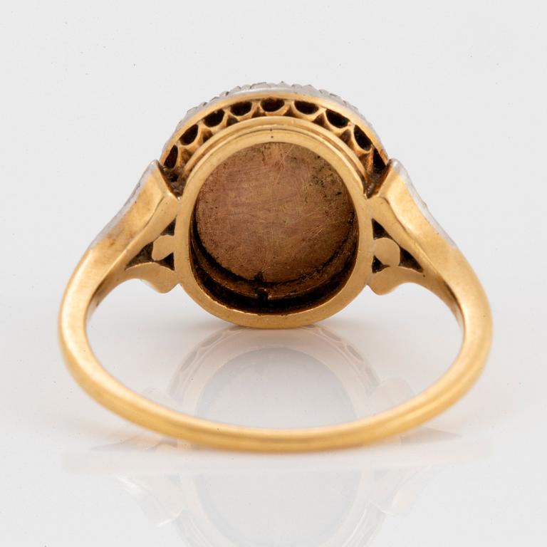 A miniature portrait ring.
