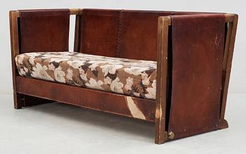 An Axel Einar Hjorth 'Funkis' brown leather and stained wood sofa, Nordiska Kompaniet, Sweden 1930's.