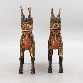 A pair of large Qilin sculptures, lacquered wood, first part of the 20th century.