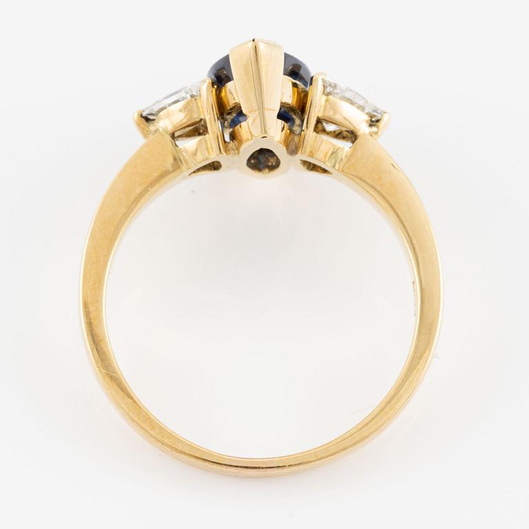 Ring, 18K gold with navette-shaped sapphire and triangle-cut diamonds.