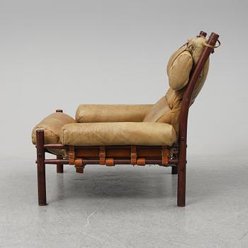 AN ARNE NORELL "INCA" LOUNGE CHAIR.