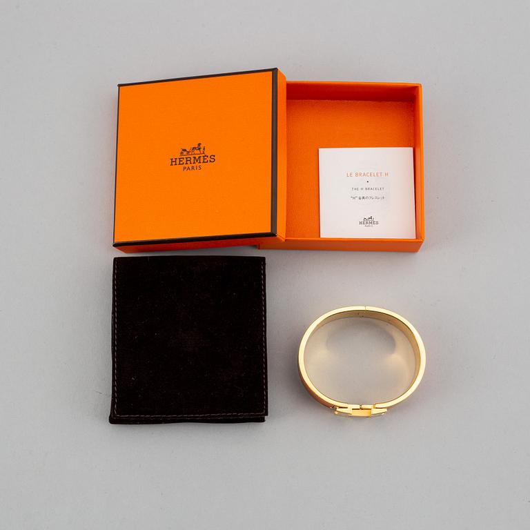 HERMÈS, a 'Clic H' bangle.
