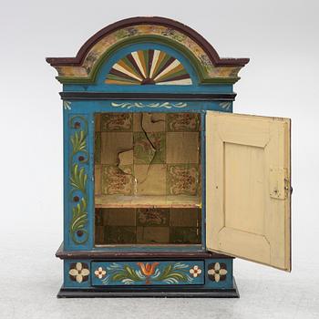 A 19th century folk art hanging cabinet.