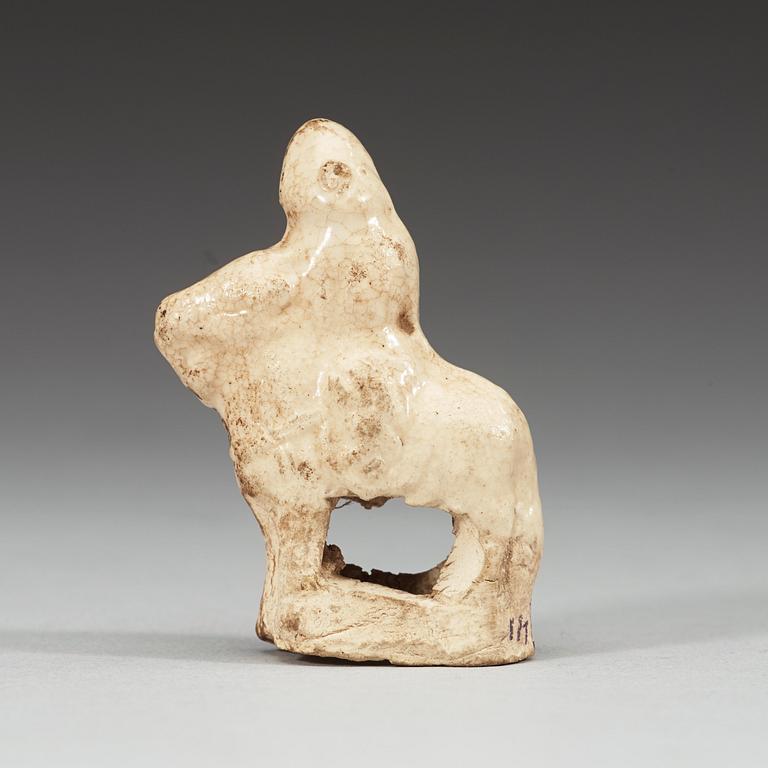 A cream-glazed miniature pottery equestrian, Song- (960-1279)/ Yuan dynasty (1271-1368).