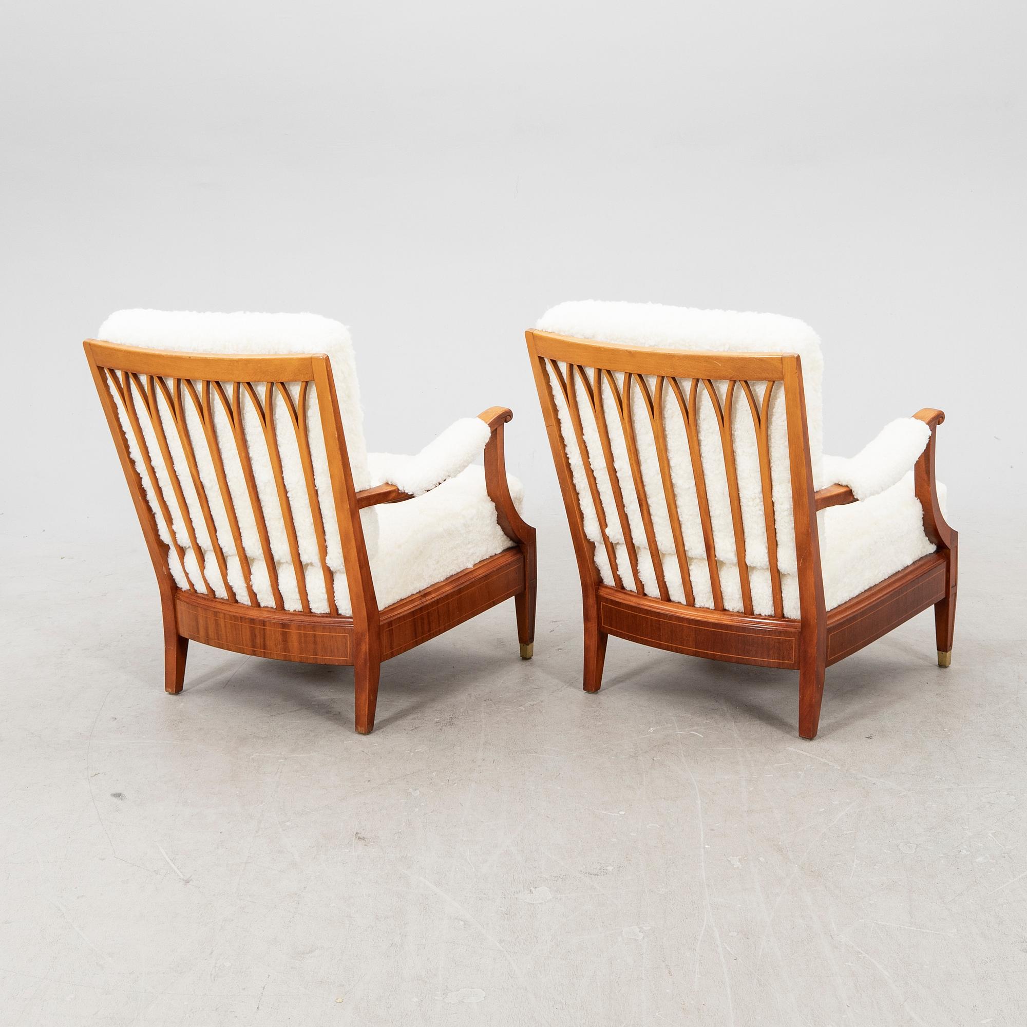 A pair of 1940s cheepskin armchairs.