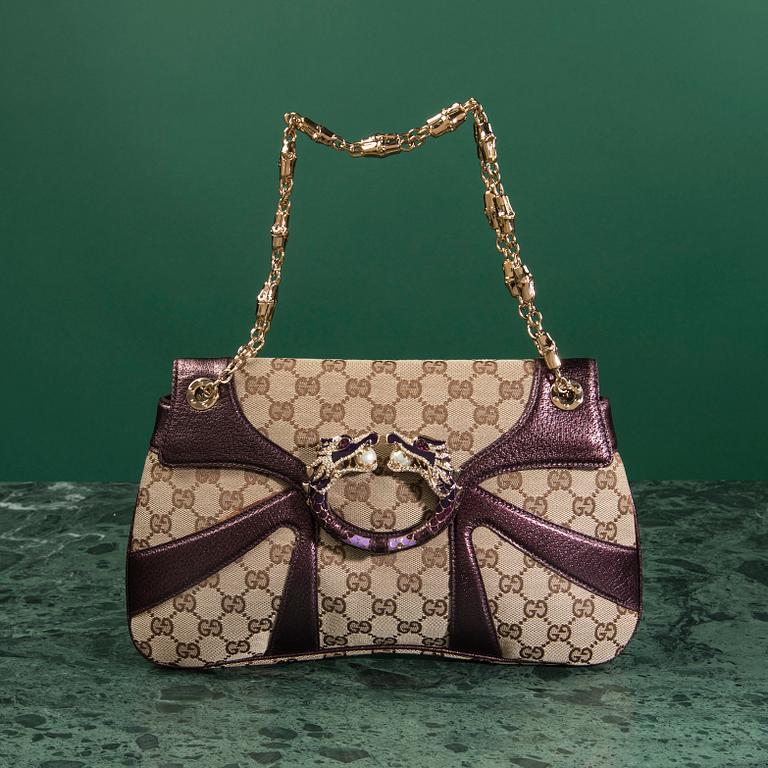 A bag VÄSKA, by Gucci.