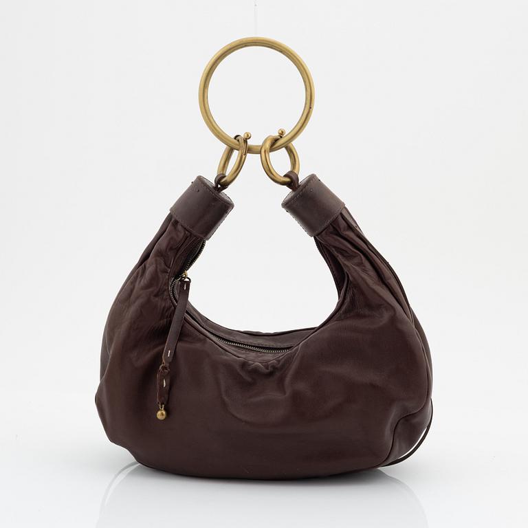 Chloé, a brown leather and brass bag.