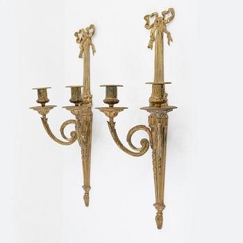 A pair of gilt brass wall sconces, Louis XVI-style, early 20th century.