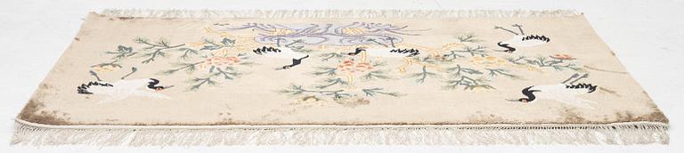 A silke figural rug, China, later part of the 20th century, ca. 92 x 170 cm.