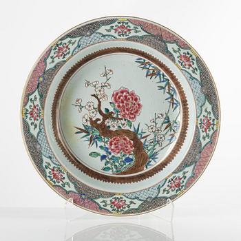 A large famille rose basin, Qing dynasty, 18th century. Decorated with prunus in bloom, peonies and bamboo to the ...