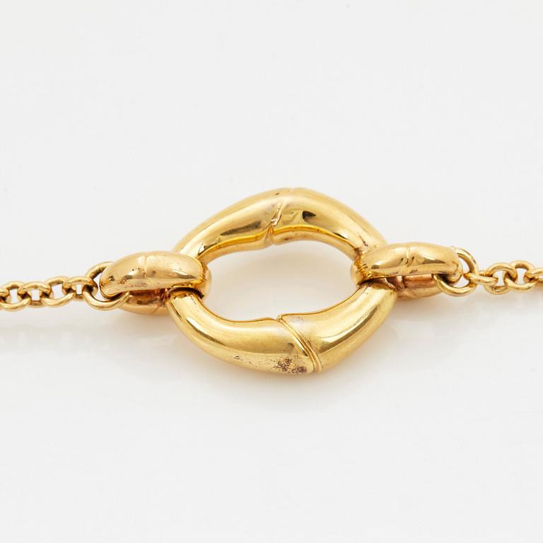 An 18K gold Gucci bracelet.
