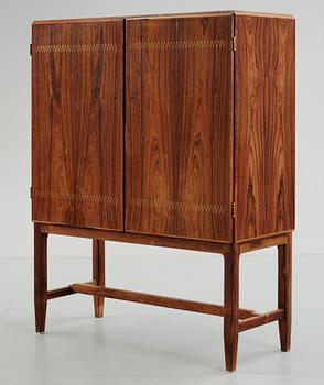 A Carl-Axel Acking palisander cabinet, Nordiska Kompaniet (NK) 1940's-50's.