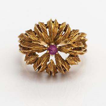An 18K gold ring with a ruby.