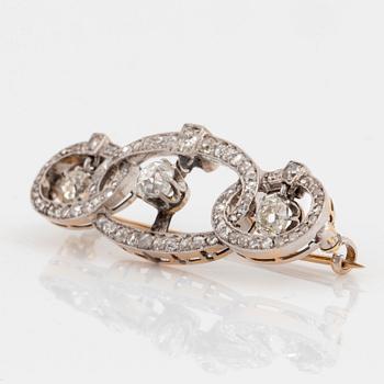 A platinum and gold brooch set with old- and rose-cut diamonds.