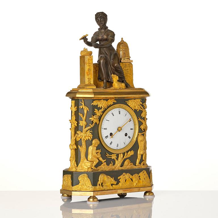 A French patinated and ormolu Directoire figural mantel clock, circa 1800.