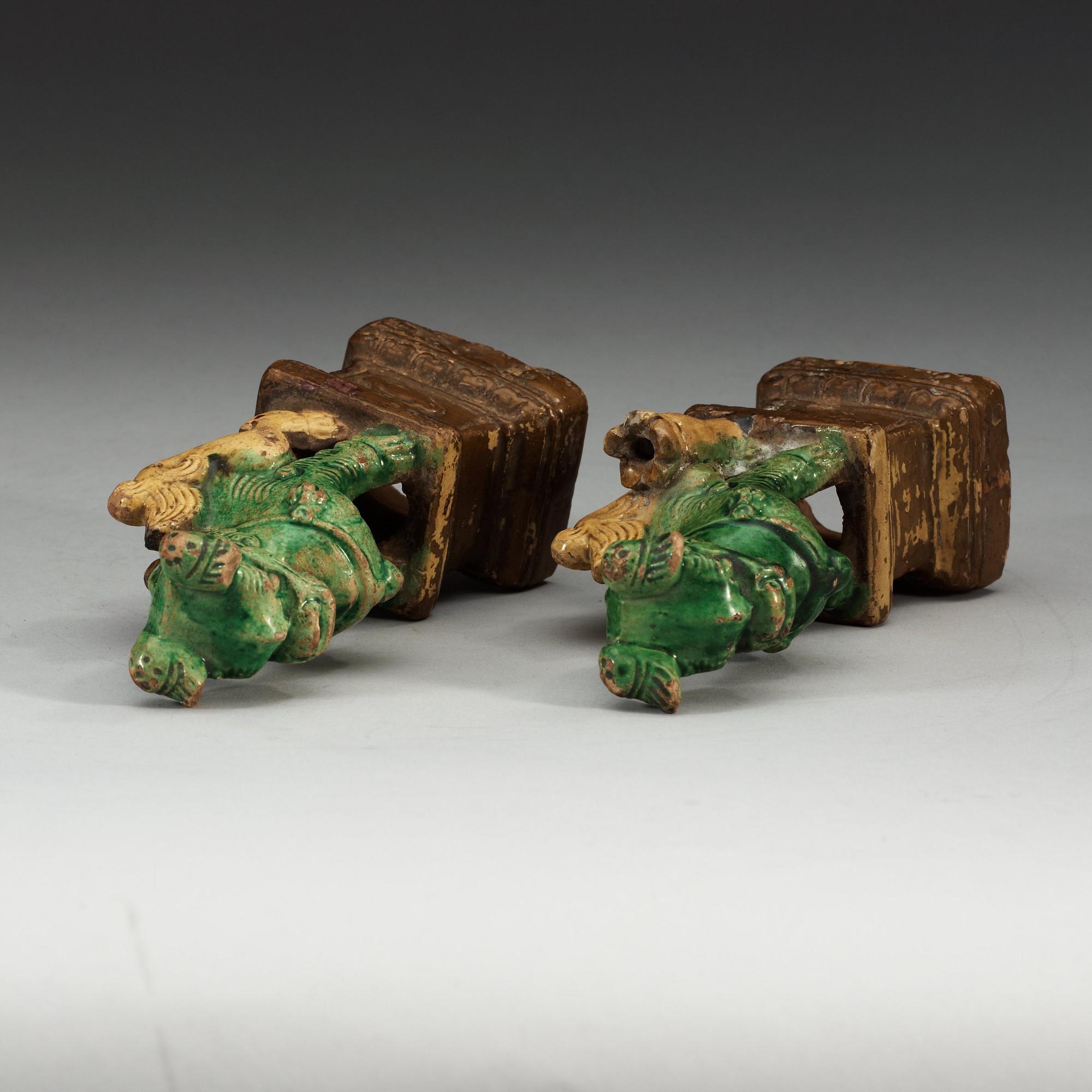 A pair of brown, green and yellow glazed joss stick holders, Qing dynasty (1644-1912).