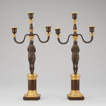 A pair of Empire early 19th century three-light candelabra.