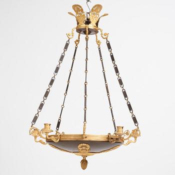 An Empire.style five-branch patinated and gilt bronze chandelier, later part of the 19th century.