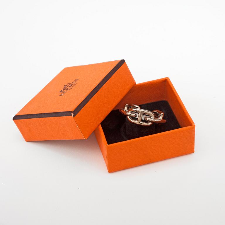 HERMÈS, a silver colored scarf buckle.