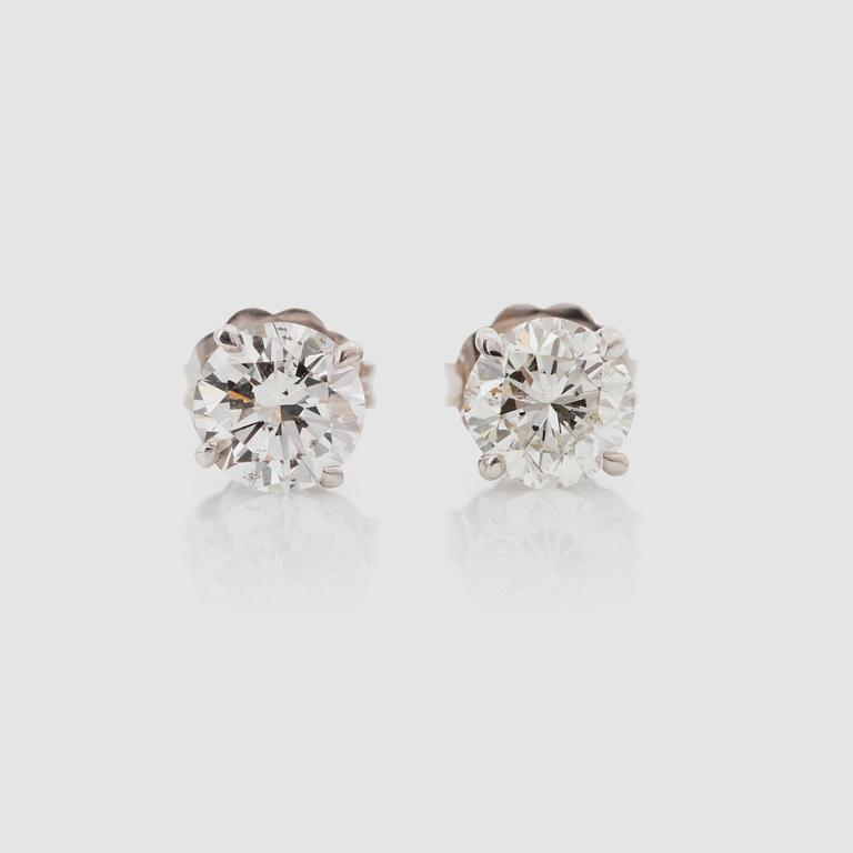 A pair of brilliant-cut diamond solitaire earrings. Total carat weight circa 1.21 cts. Quality circa J/SI.