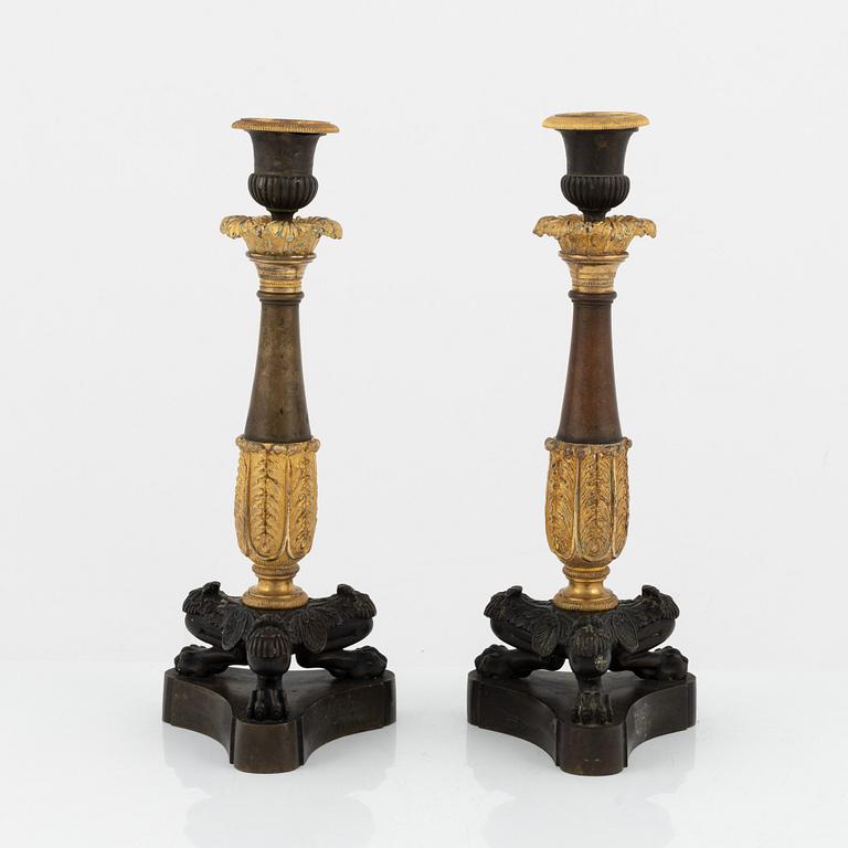 A pair of 19th century empire-style bronze candlesticks.
