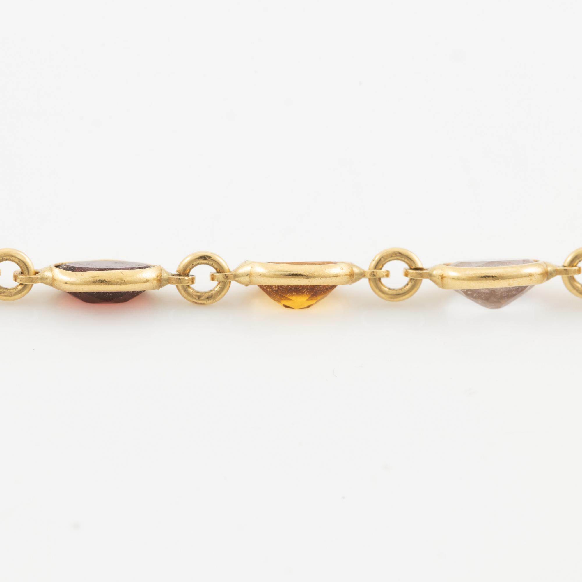 Necklace in 18K gold set with, among other stones, peridot, topaz, citrine, and amethyst.