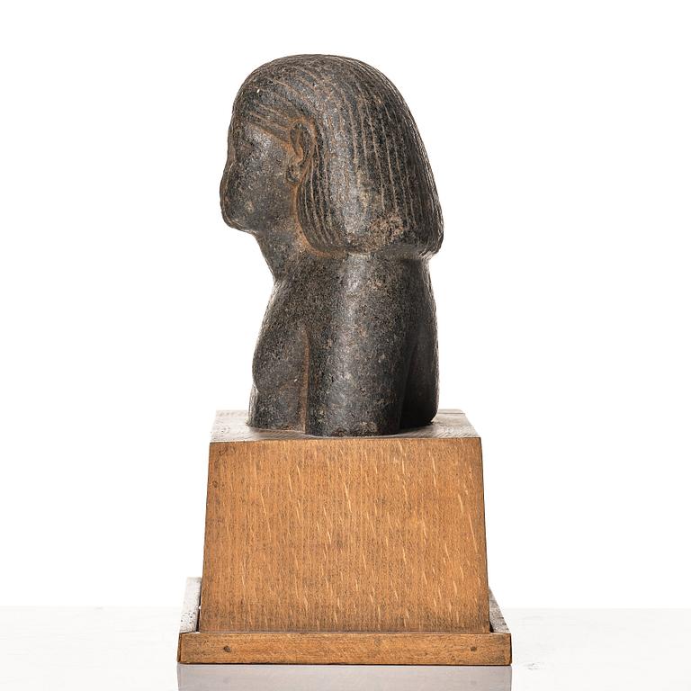 An Egyptian granite bust of an official, Middle Kingdom ca 1900 B.C.