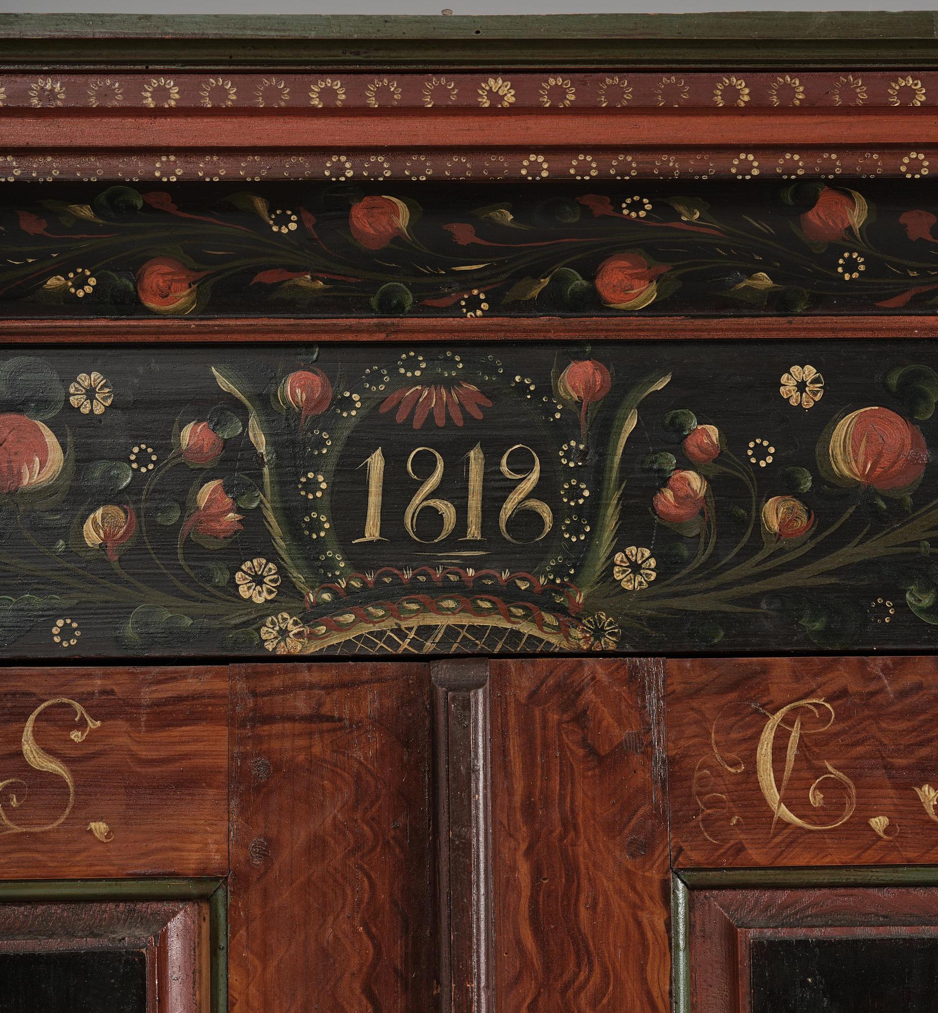 A Swedish polychrome painted folk art corner cabinet, dated 1818.