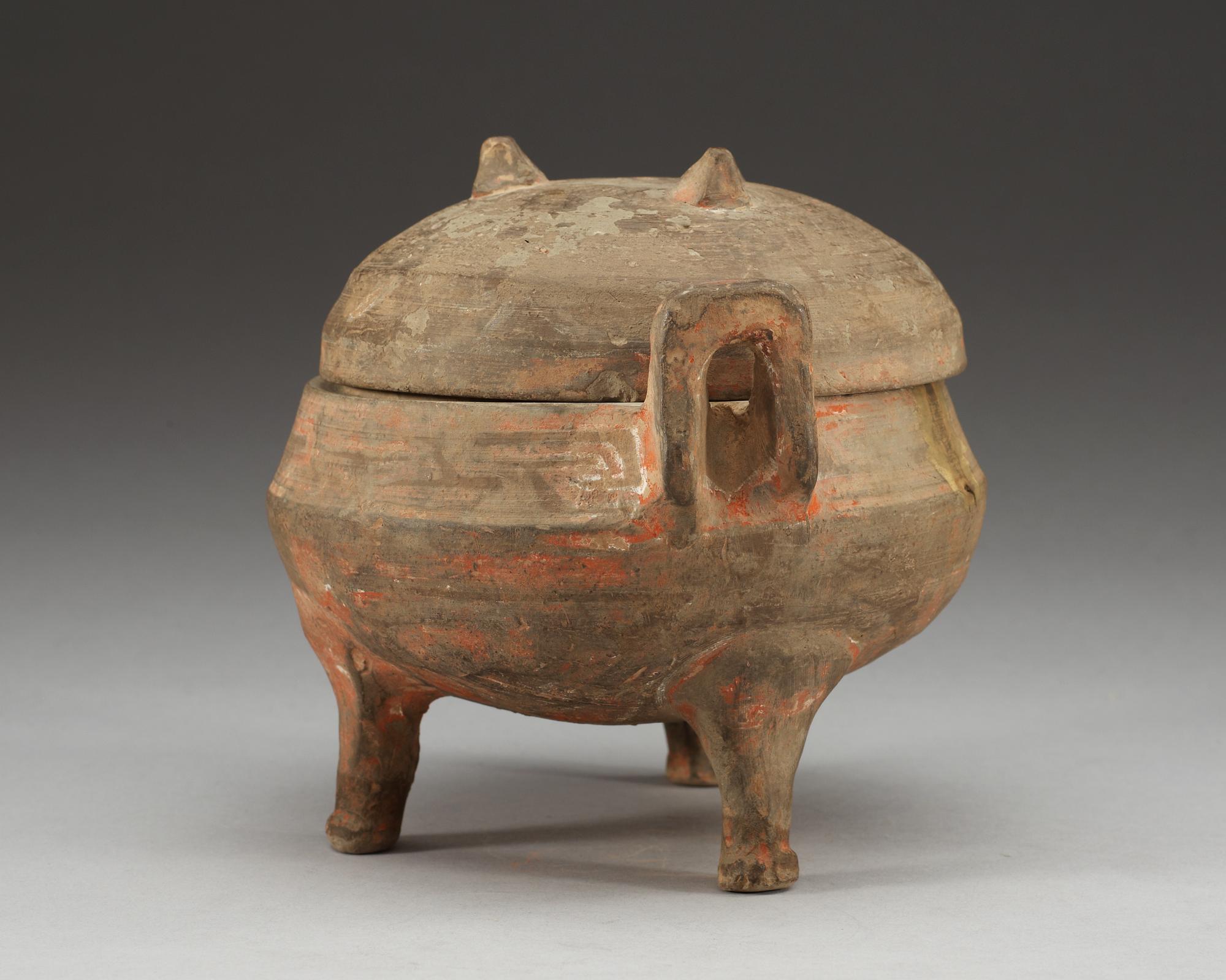 A potted ding tripod censer with cover, Han dynasty (206 BC - 220 AD).
