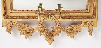 A Gustavian giltwood two-branch girandole mirror, Stockholm, late 18th century.