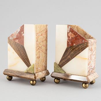 An Art Déco marble mantle clock and a pair of book ends, 1920's.
