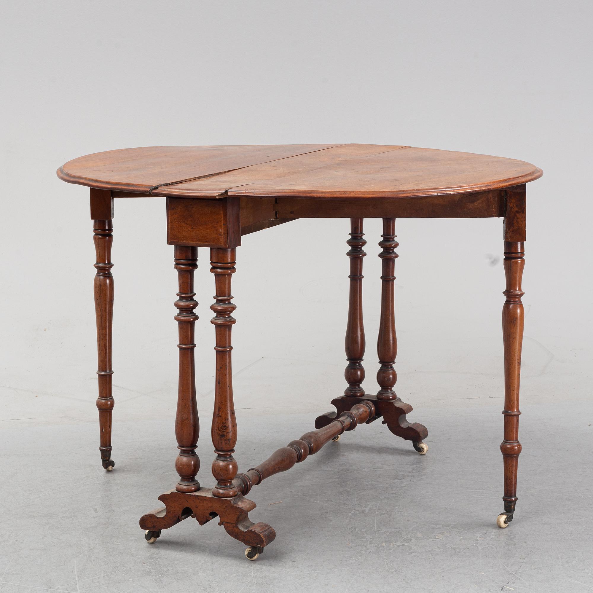 A neo-renaissance mahogany drop-leaf table from secord half of 19th century.