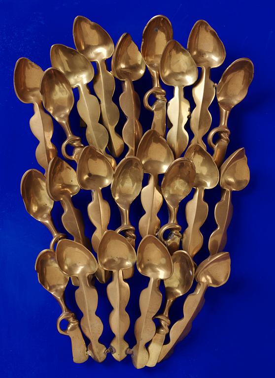 Arman, polished bronze mounted on Klein blue wooden panel, signed and numbered XIX/XXX.