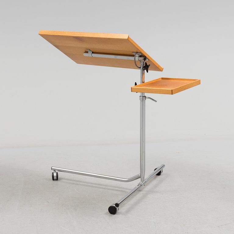 A teak reading table, second half of the 20th Century.