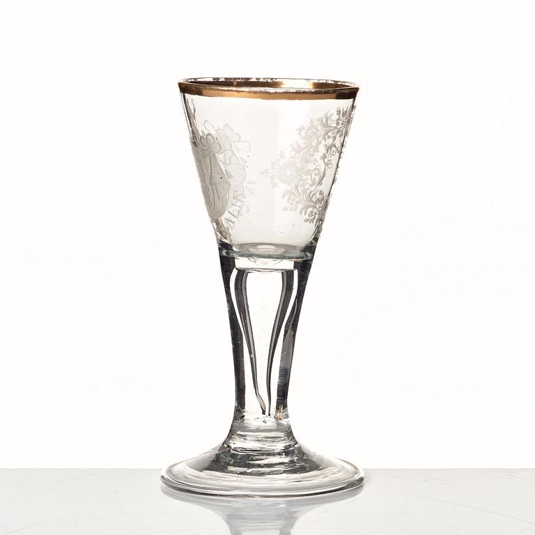 An engraved and gilded armorial wine glass, 18th Century.