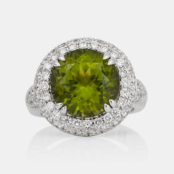 557. A Burmese 8.50 ct peridot and pavé-set diamond ring. Total carat weight of diamonds circa 2.00 cts.