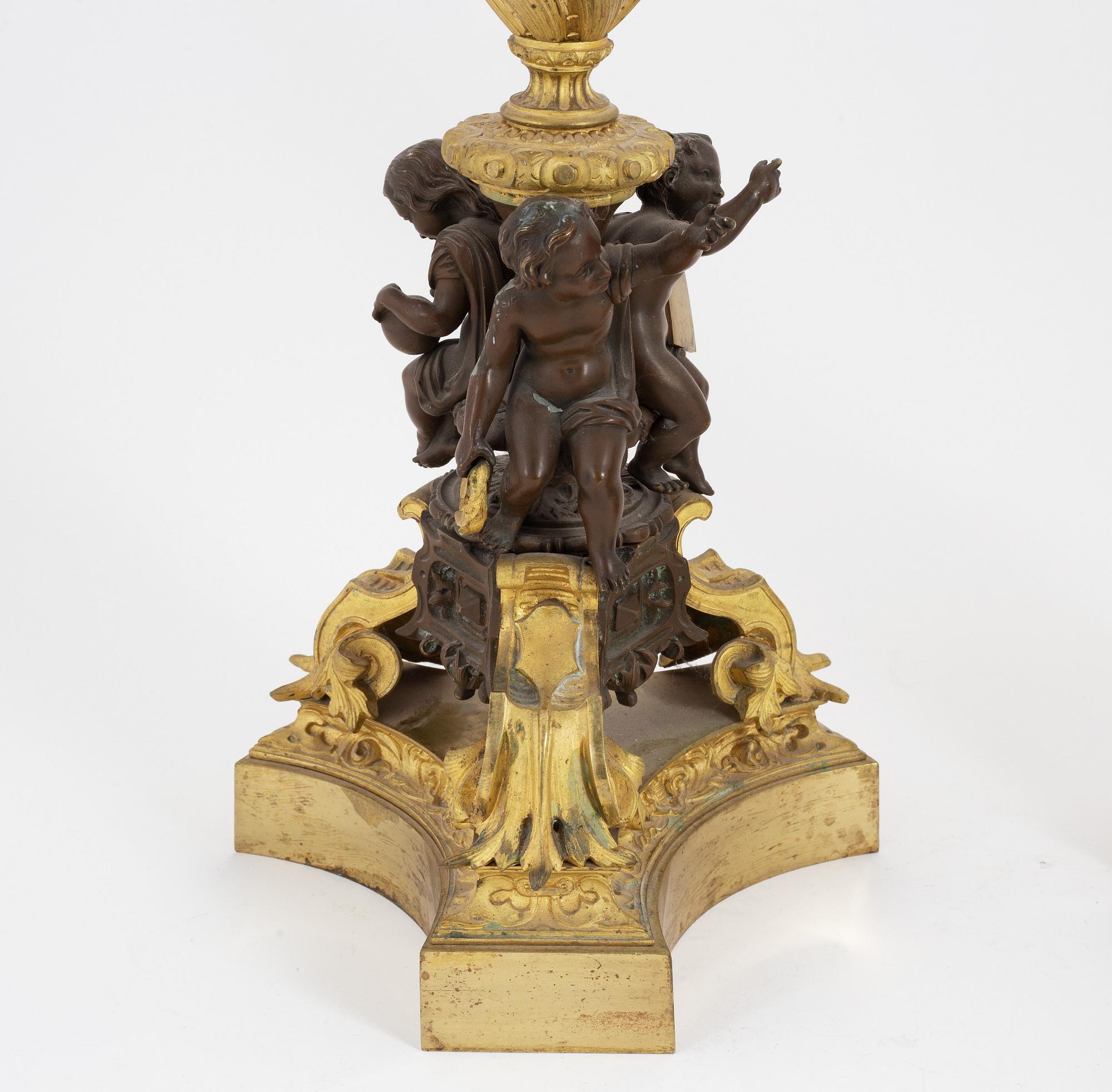 A pair of patinated bronze and ormolu neo-renaissance six-light candelabra, later part of the 19th Century.