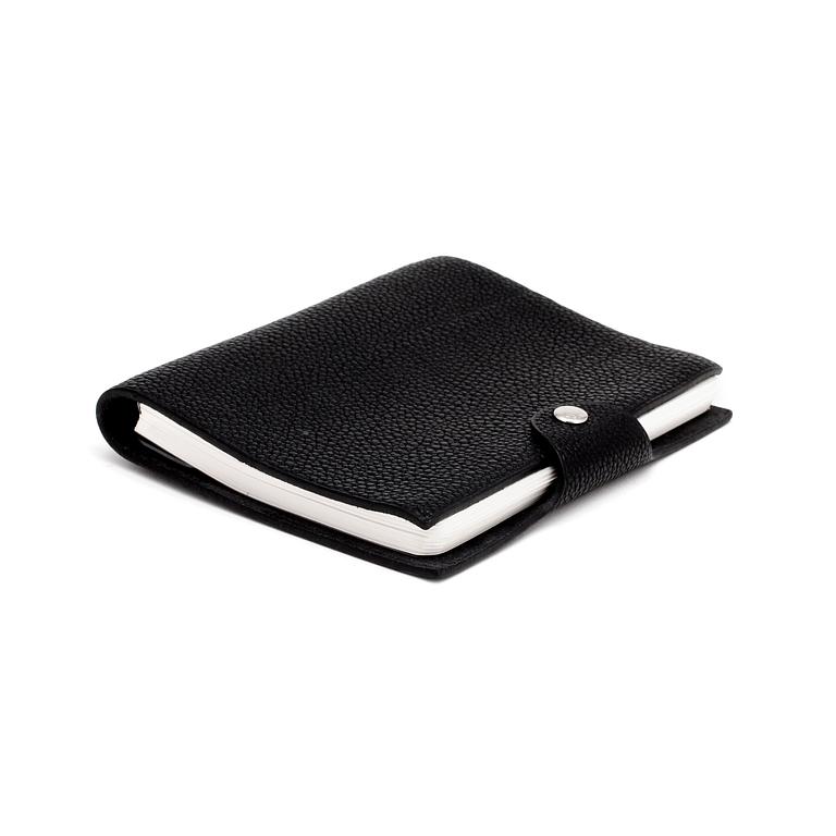 HERMÈS, a black leather notebook, "Ulysse Petit Modèle".