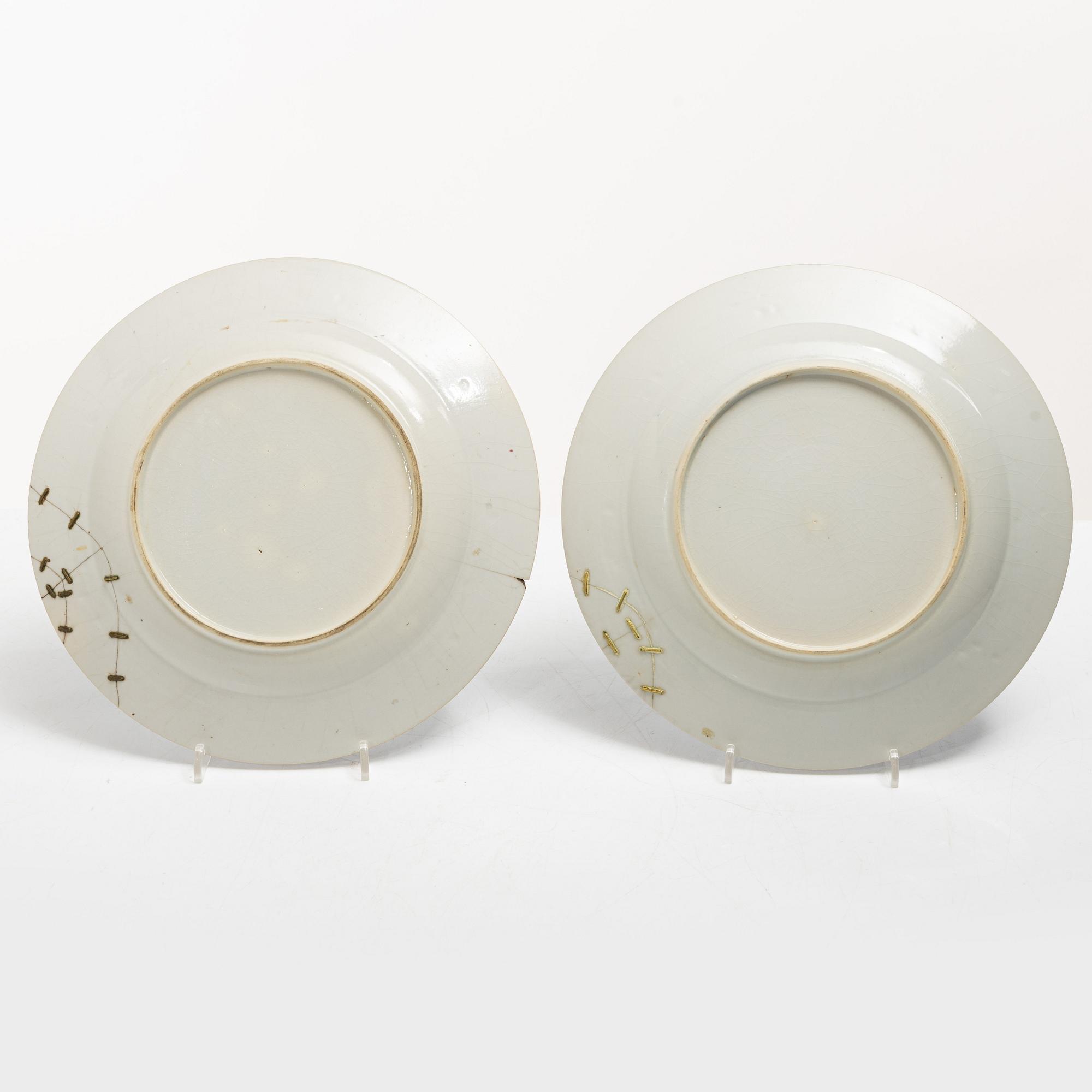 A pair of armorial dinner plates, soft paste, Qing dynasty, 18th century.