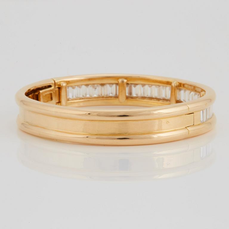 An 18K gold bracelet set with baguette-cut diamonds 7.715 cts according to engraving.