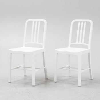 A pair of plastic 'Navy Chair' by Emeco.