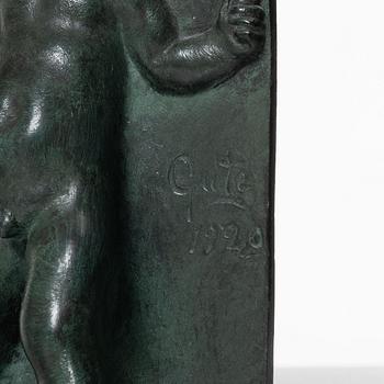 Axel Gute, a pair of patinated bronze bookends, dated 1920.