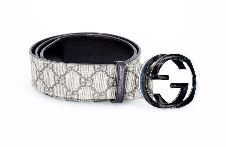 A monogram canvas belt by Gucci.