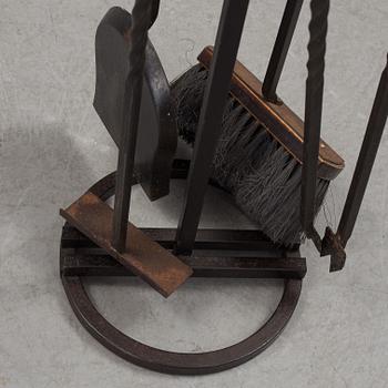 A set of 5 iron and brass fire utensils with stand, 20th Century.